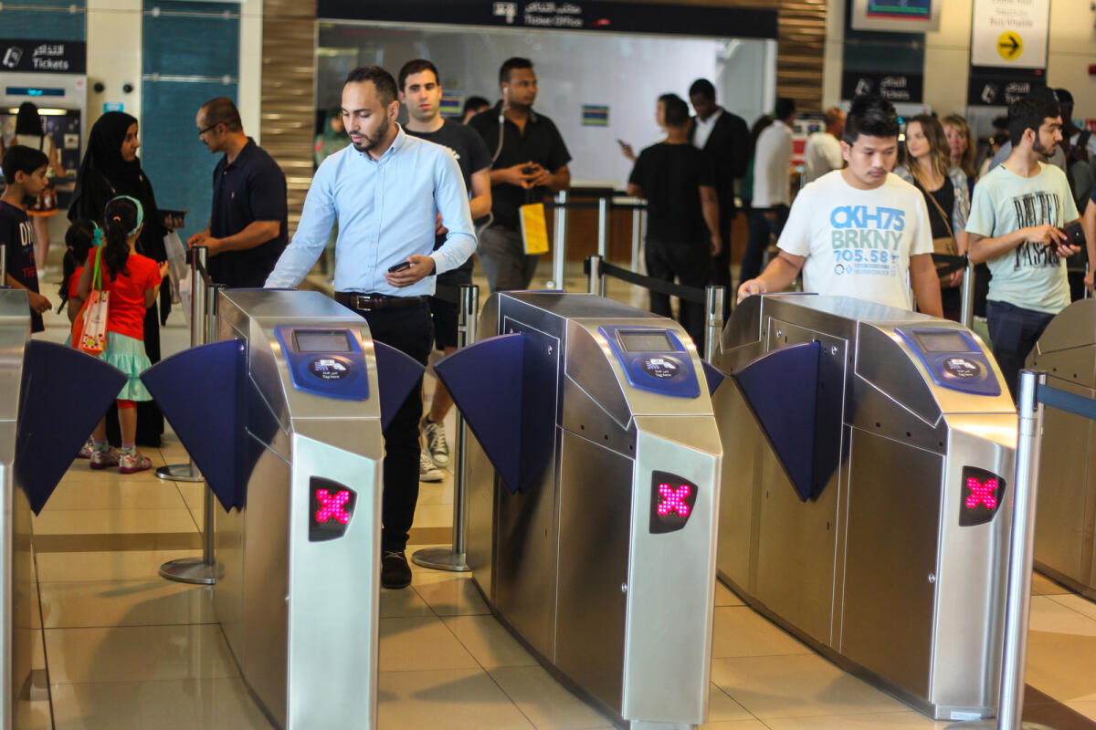 Passengers swiping their NOL card on the check in counter at Dubai Mall Metro Station. KT Photo: Neeraj Murali.