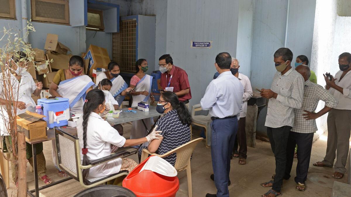 People queue up to get inoculated with the Covid-19 vaccine in Hyderabad. Photo: AFP