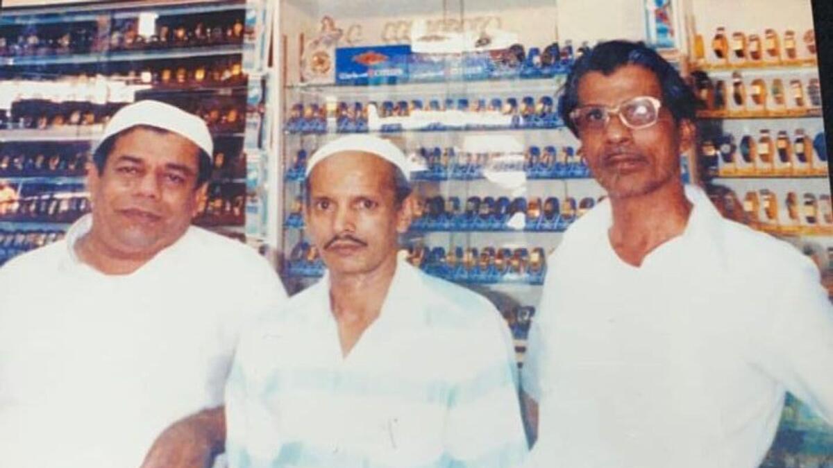 Abubakr Motai (left) with the owner of Al Hamra, Moidu (right) and a family member (center)