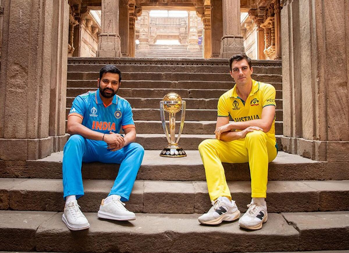 Indian captain Rohit Sharma and Australia's captain Pat Cummins pose with the ICC World Cup trophy in Ahmedabad. — PTI