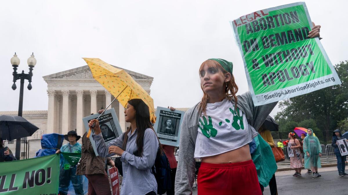 An abortion-rights protester reacts as she is heckled by an anti-abortion protester, Thursday, June 23, 2022, outside the Supreme Court in Washington. (AP Photo/Jacquelyn Martin)