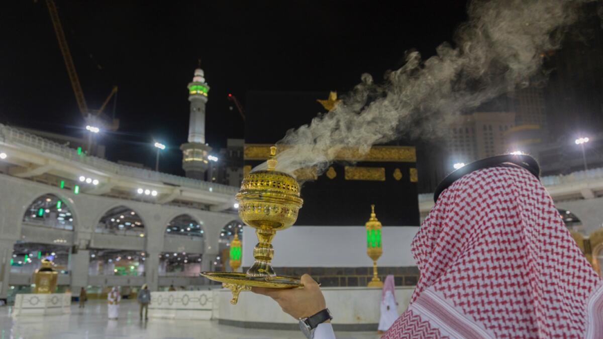 A man burns incense as the area around the Holy Kaaba is prepared for pilgrims, in Makkah, Saudi Arabia. Photo: AP