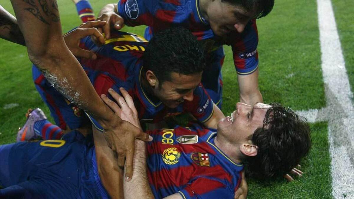 Messi is congratulated by Pedro and Bojan Krkic after scoring against Arsenal in the Champions League quarter-final in April 2010.