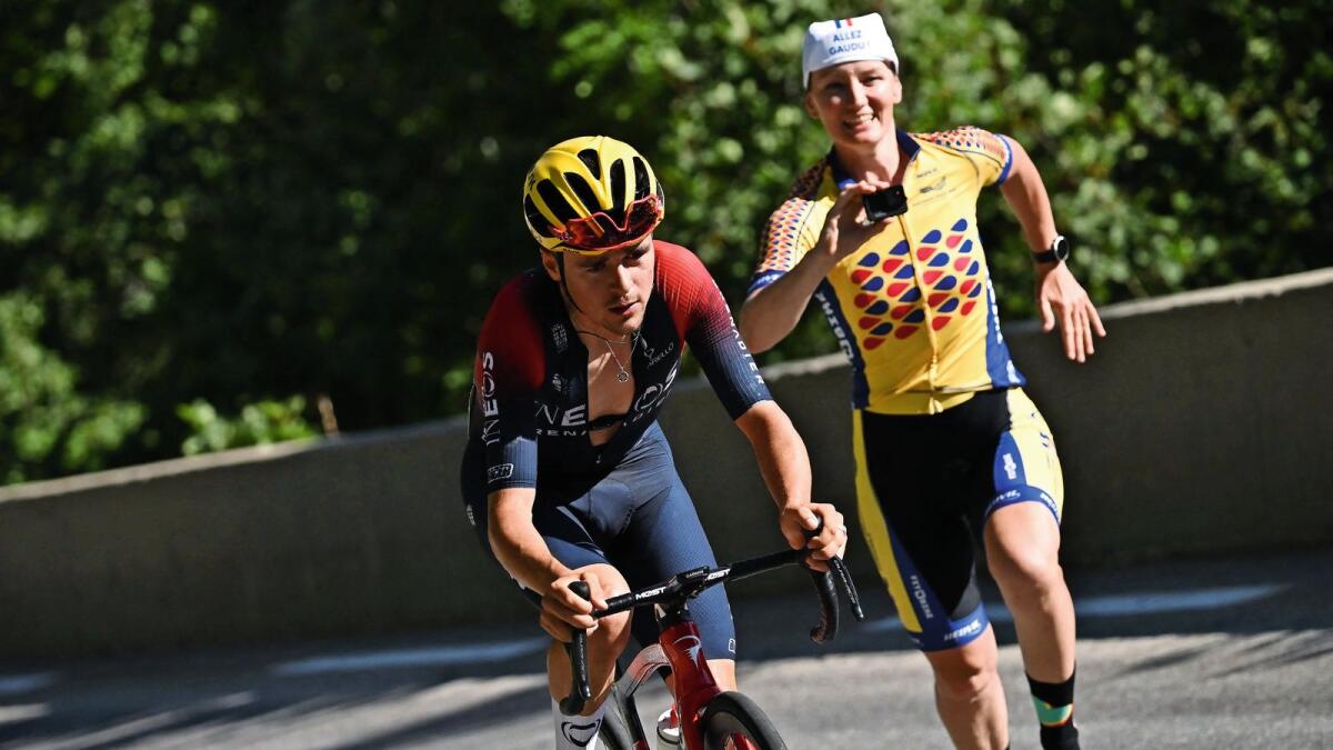 Ineos Grenadiers team's British rider Thomas Pidcock (left) cycles in a lone breakaway in the ascent of Alpe d'Huez during the 12th stage of the Tour de France on Thursday. — AFP