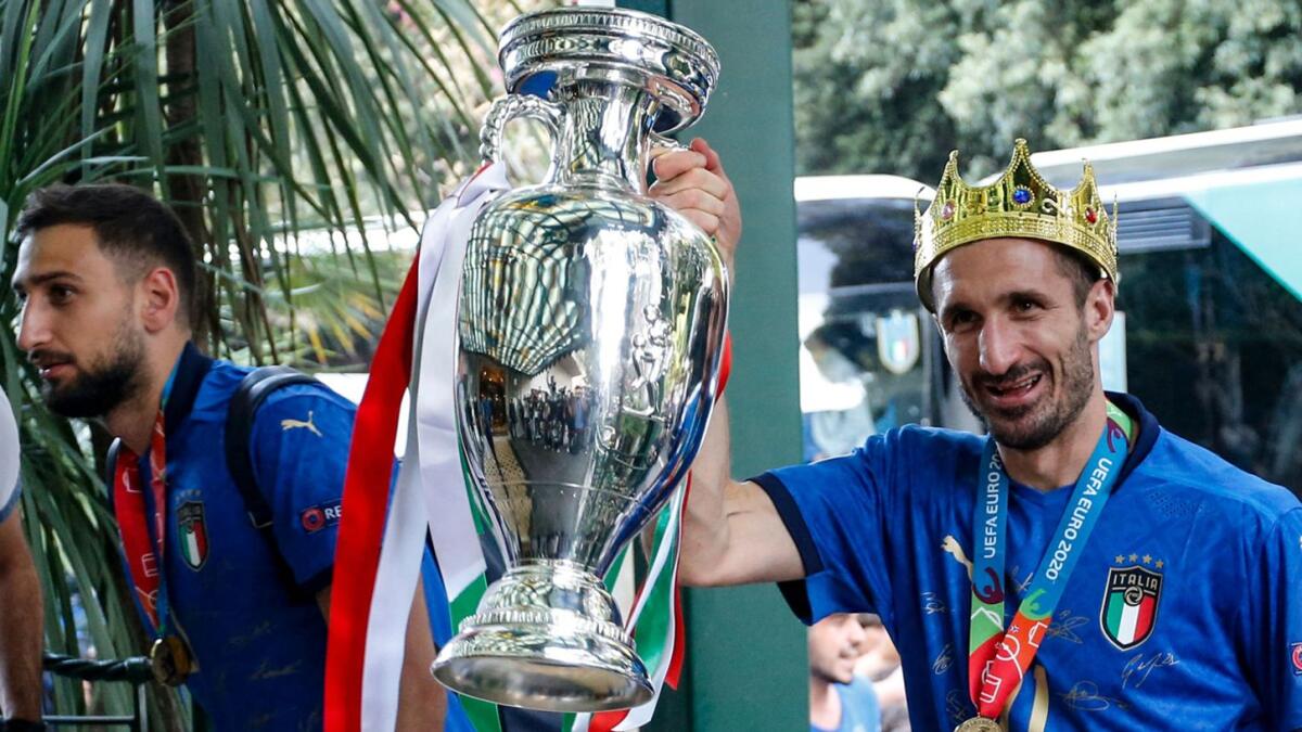Italy's captain Giorgio Chiellini (right) carrying the trophy next to goalkeeper Gianluigi Donnarumma as Italy's football team arrive in Rome after Italy they won the Uefa Euro 2020 final against England. — AFP