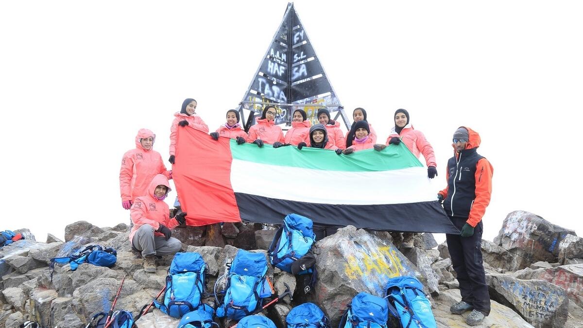 Asma Al Qayedi and Sajaya Young Ladies raise the UAE Flag on top of Tokubal Mountain.- Supplied photo