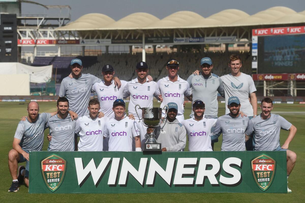 The England team pose with the trophy in Karachi on Tuesday. — AFP