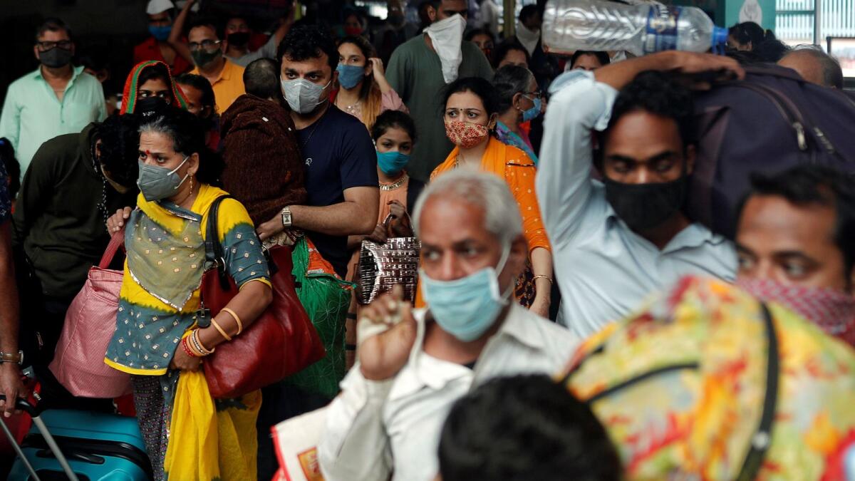 People wearing protective masks exit a railway station amid the spread of Covid-19 in Mumbai. Reuters
