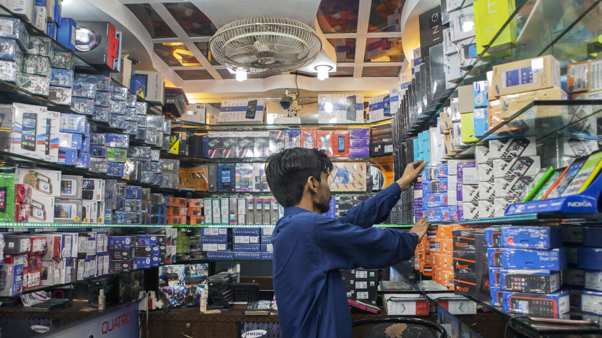 Mobile phones are displayed at a store in Karachi. Pakistan will generate Rs4.5 billion by increasing by five per cent the duty on the import of 289 items. — Bloomberg