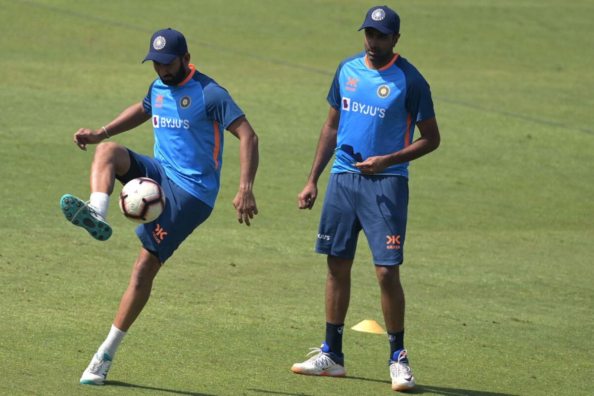 India's Cheteshwar Pujara (left) and Ravichandran Ashwin during a practice session at the Arun Jaitley Stadium in New Delhi on Thursday. — AFP