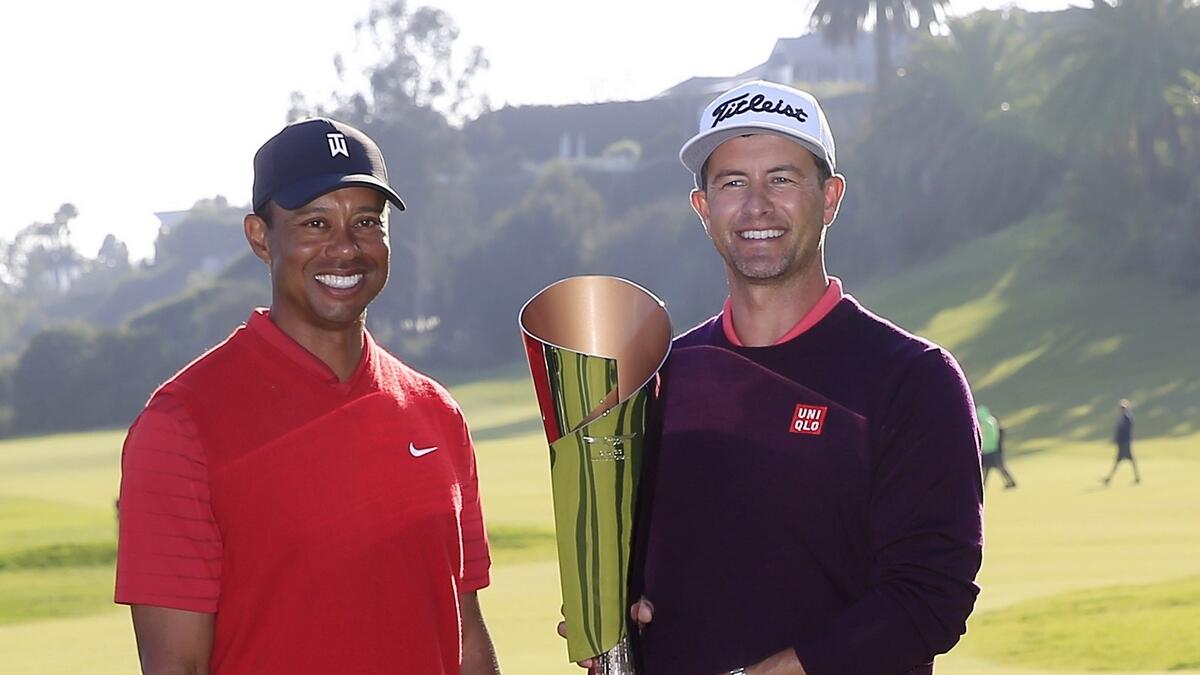 Adam Scott of Australia poses with tournament host Tiger Woods and the trophy after winning the Genesis Invitational