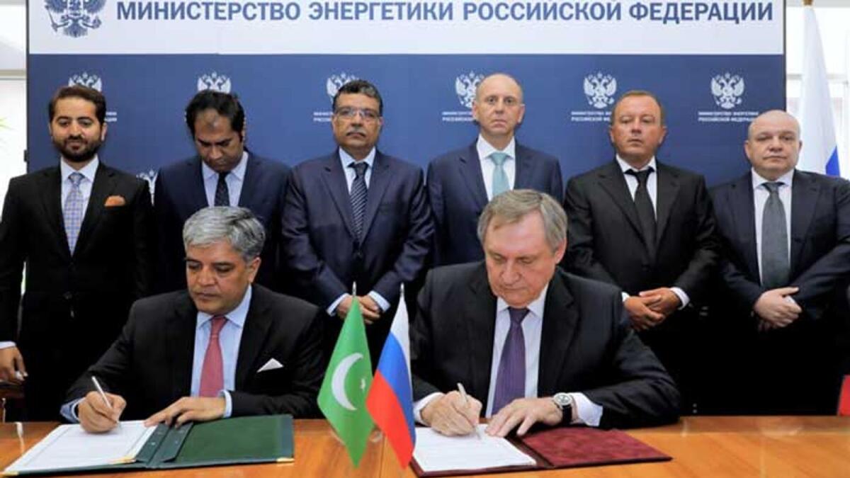 Pakistani envoy Shafqat Ali Khan signing protocol agreement with Russia's Energy Minister Nikolay Shulginovin in Moscow.