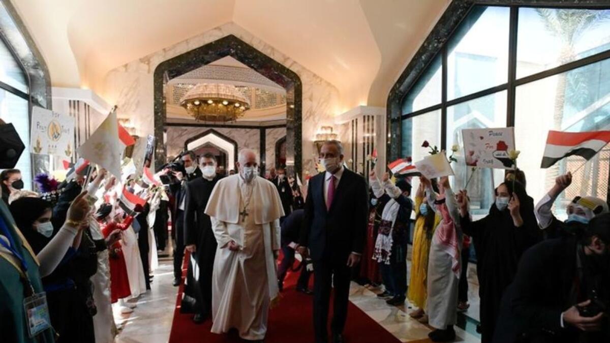 Iraqi Prime Minister Mustafa Al-Kadhimi with Pope Francis upon his arrival at Baghdad International Airport. Photo: Reuters