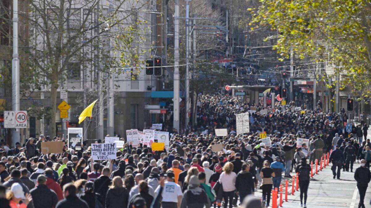 Thousands of anti-lockdown protestors march on the streets of the central business district of Sydney. — AFP