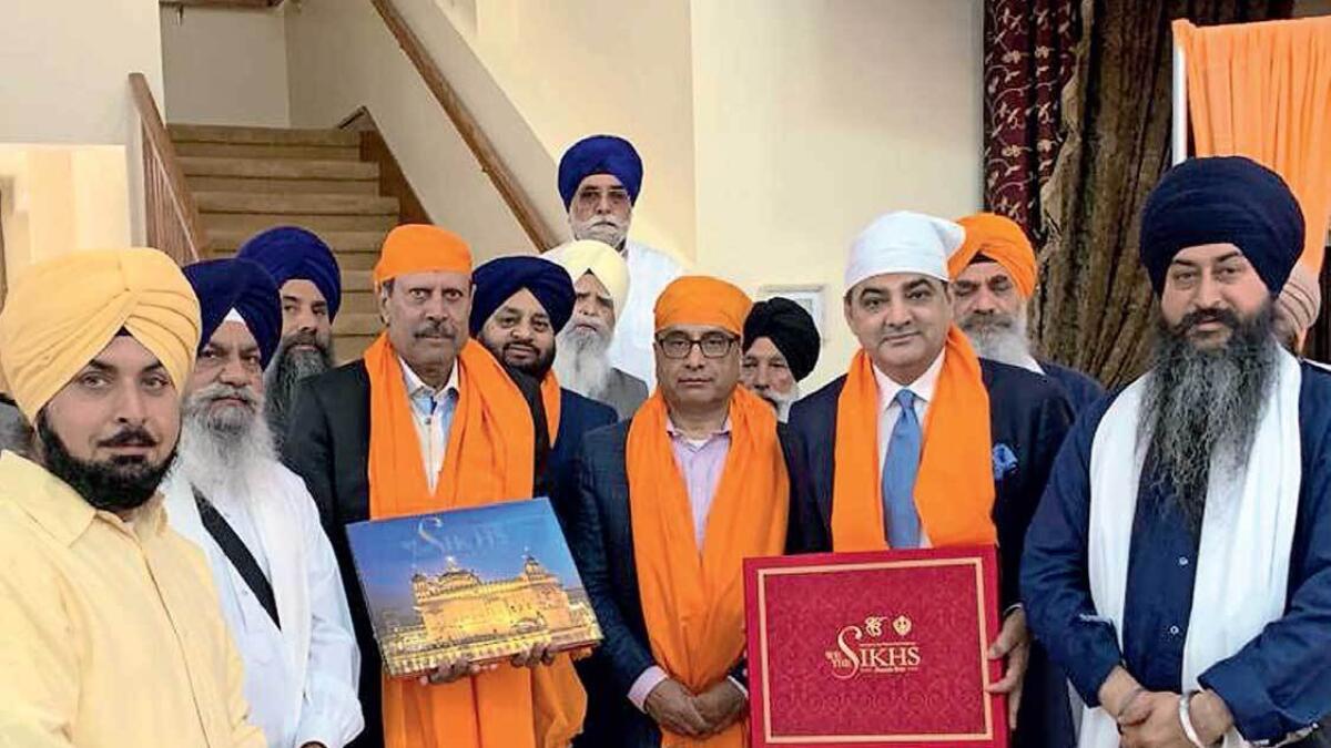 Kapil Dev and Ajay Sethi, along with community leaders in the US, in a gathering to promote their coffee table book on  Sikhism.