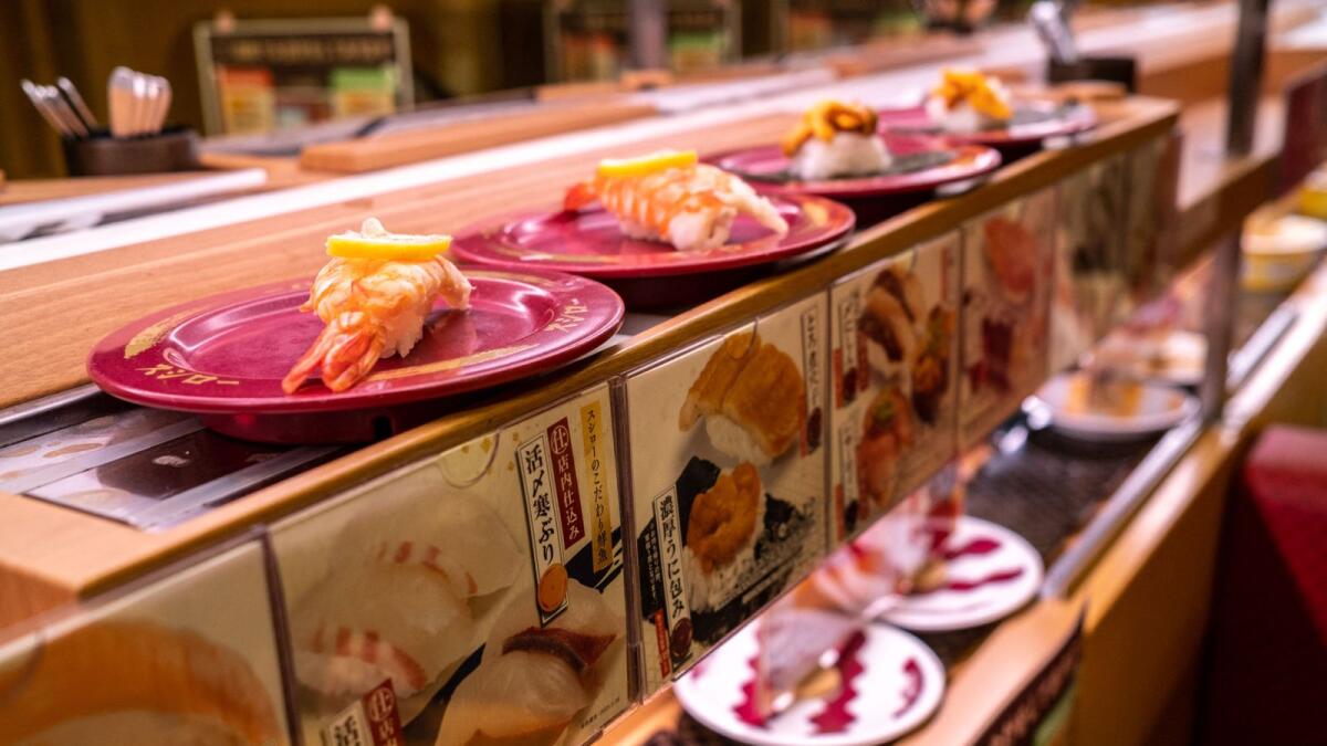 Plates of sushi on a conveyor belt at a sushi chain restaurant in Tokyo. — AFP