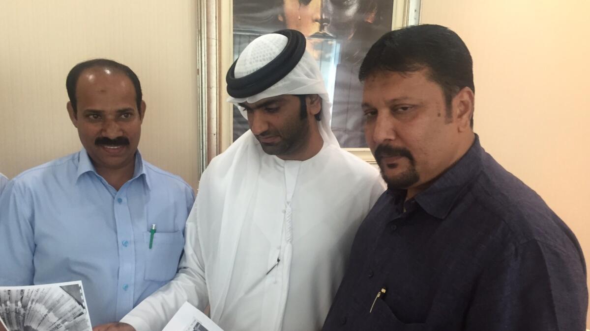 Advocates Abdullah (centre) and Mahamood (right) showing the photocopies of fake Indian currency notes seized by Sharjah Police at their office in Sharjah on Sunday.