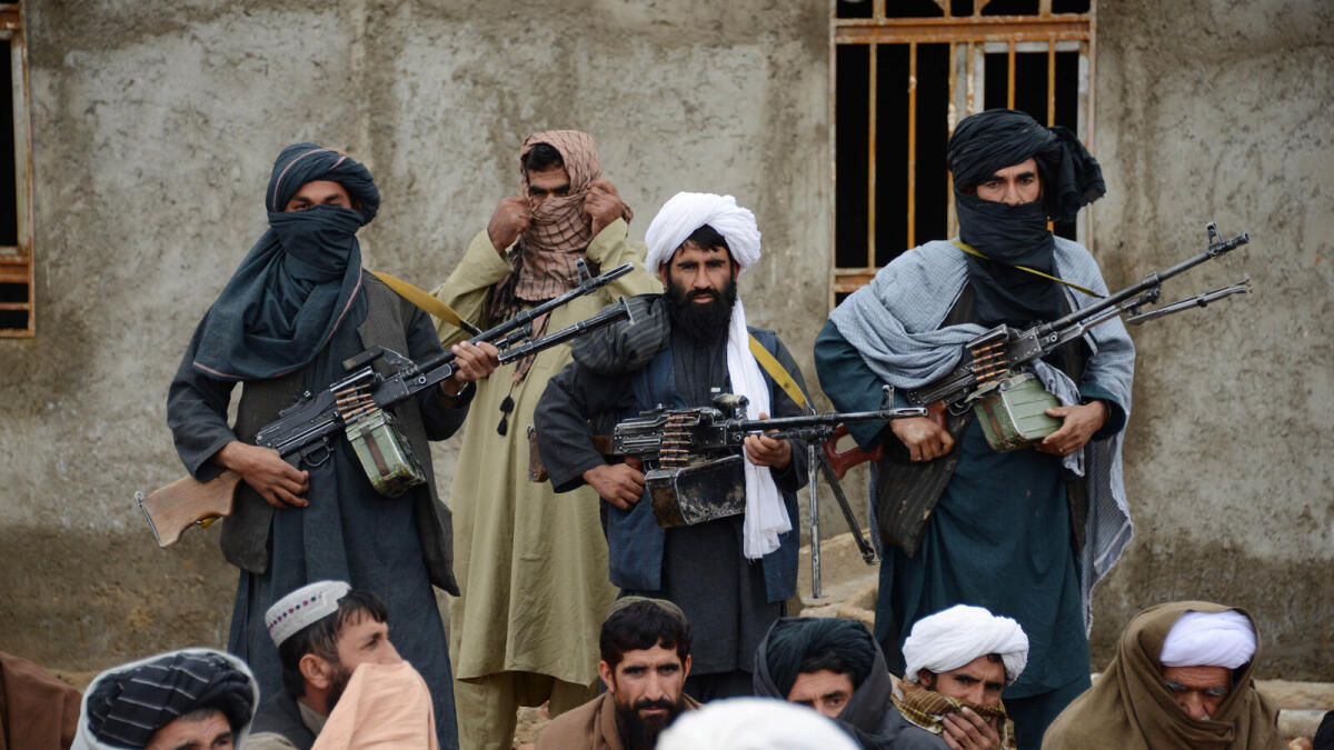 FILE - In this Tuesday, Nov. 3, 2015 file photo, Afghan Taliban fighters listen to Mullah Mohammed Rasool, unseen, the newly-elected leader of a breakaway faction of the Taliban, in Farah province, Afghanistan. Afghanistan?s Taliban are closing ranks around their new leader after months of infighting that followed the death of Mullah Mohammad Omar, which could allow the insurgents to speak with one voice in hoped-for peace talks but will also strengthen them on the battlefield.(AP Photo, File)