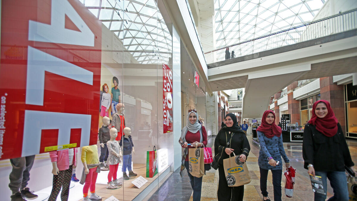 Shoppers at a mall in Dubai. The modest rate of discounting quickened slightly from December and was the fastest for five months, with firms often choosing to offer price promotions in a bid to attract sales. - KT file