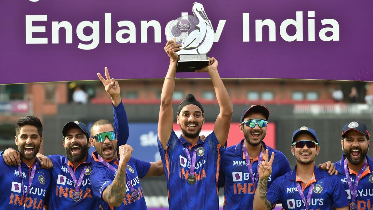 Indian players pose with the trophy after winning the third One Day International against England at Old Trafford. — AP