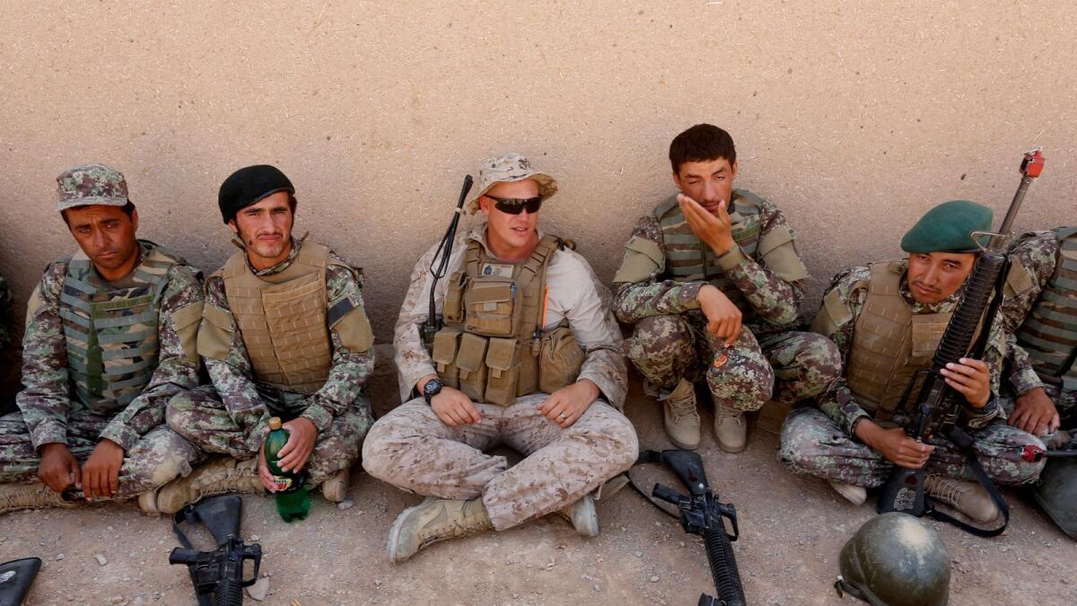 A US Marine (Centre) with Afghan National Army soldiers during a training session in Helmand province of Afghanistan.