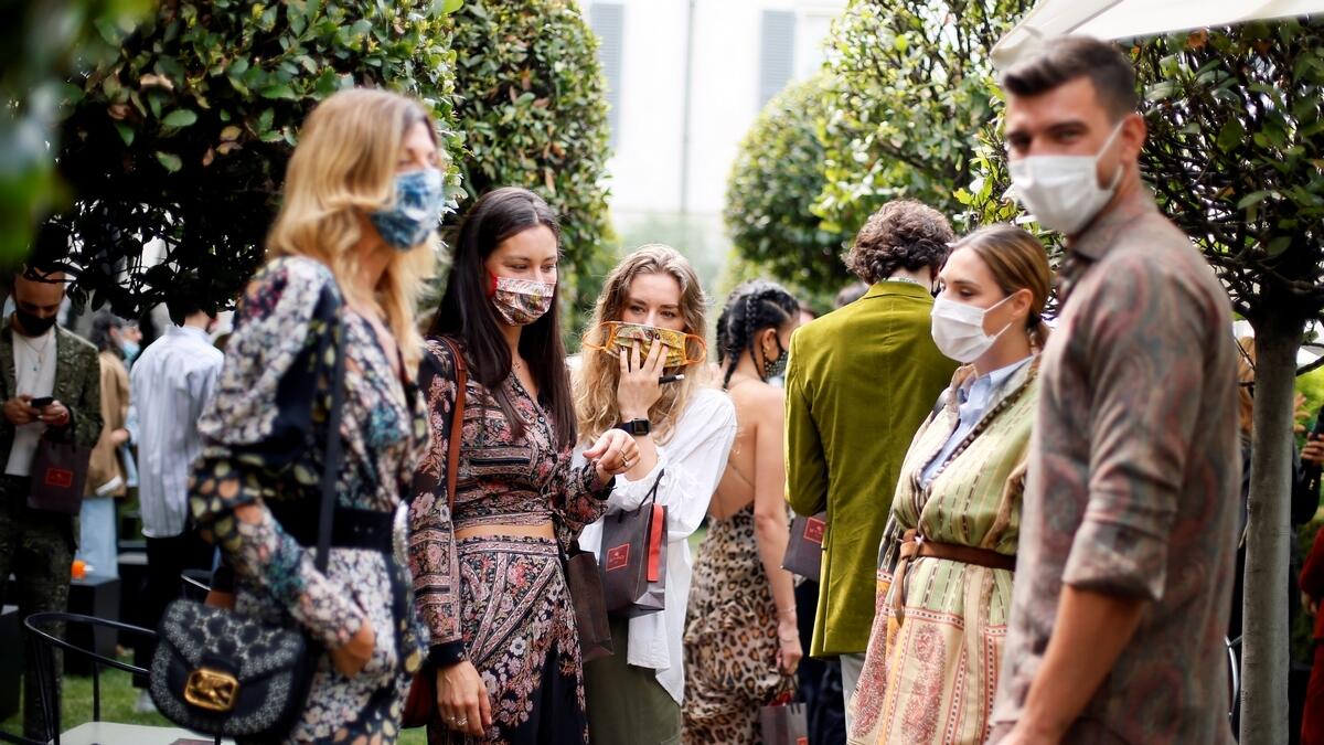 Guests gather at the end of the fashion show held in Milan with masks in place, in a dramatic departure from previous live shows.