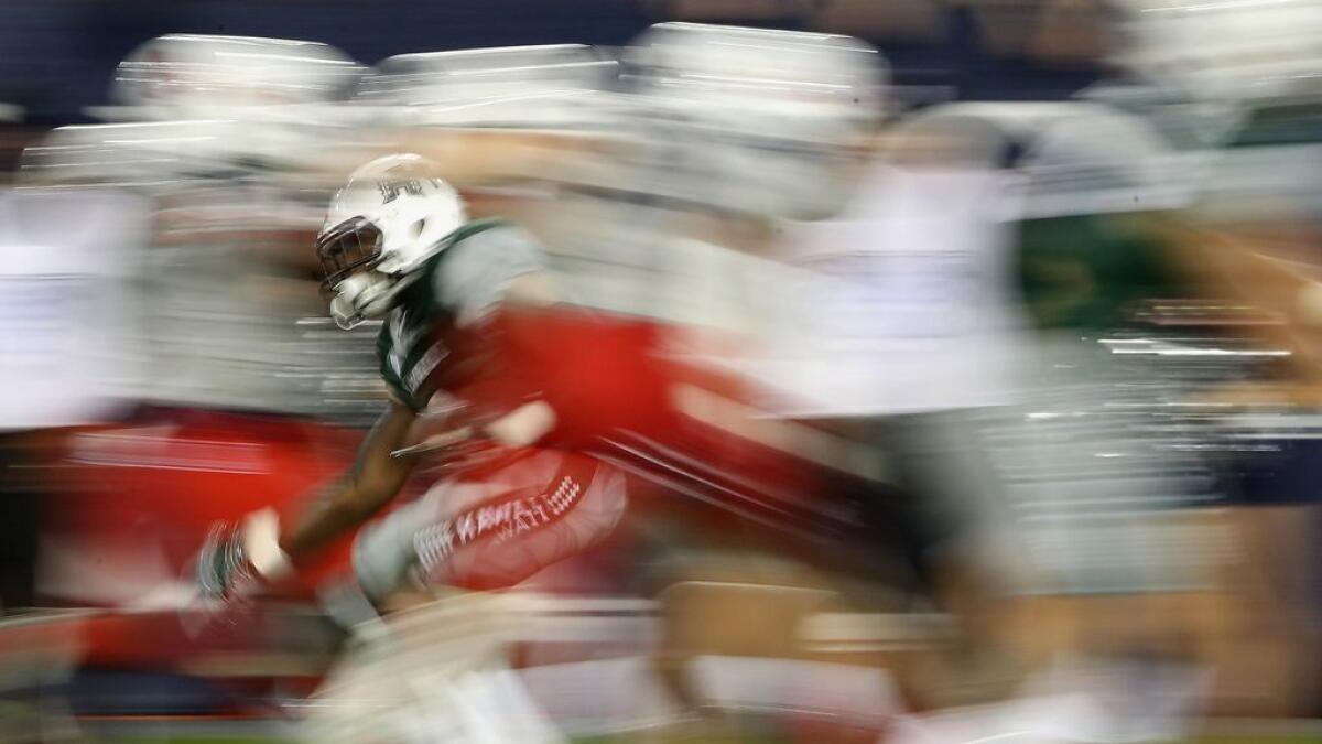 Running back Paul Harris #6 of the Hawaii Warriors rushes the football against the Arizona Wildcats during the third quarter of the college football game at Arizona Stadium.-AFP