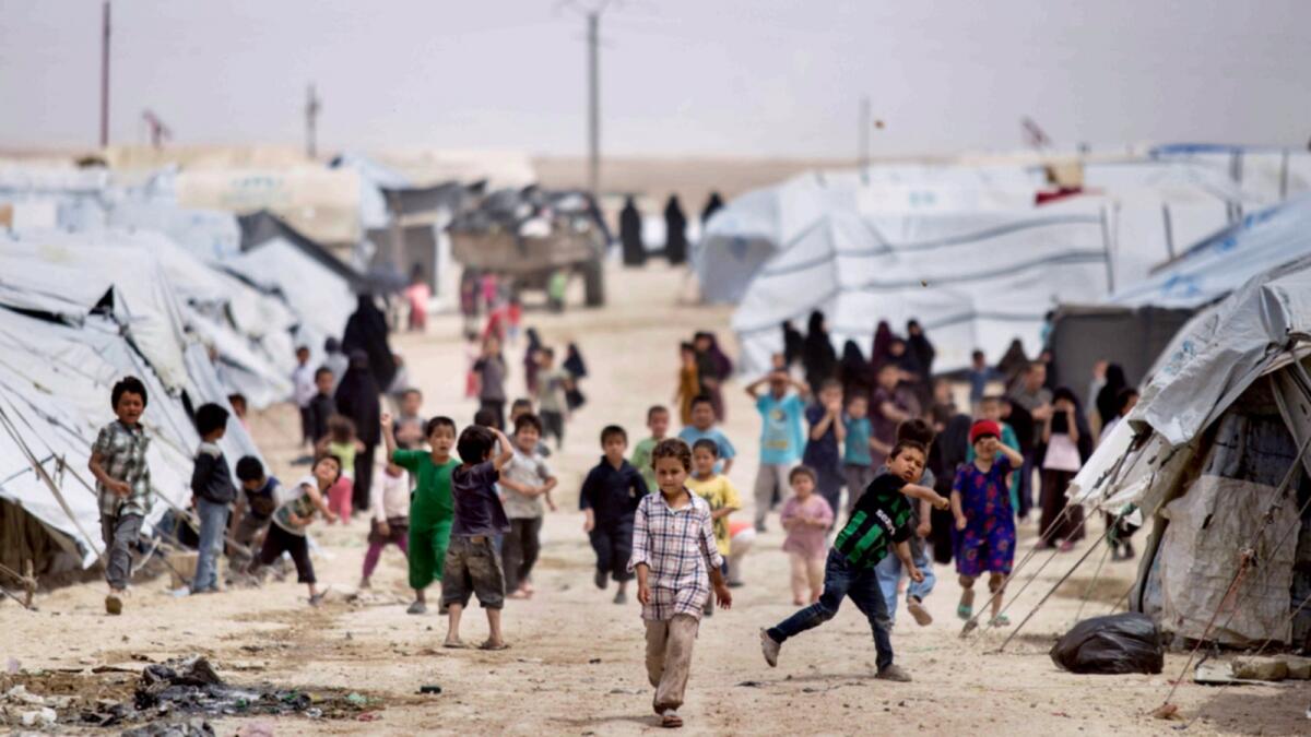 Children gather outside their tents at Al Hol camp. — AP file