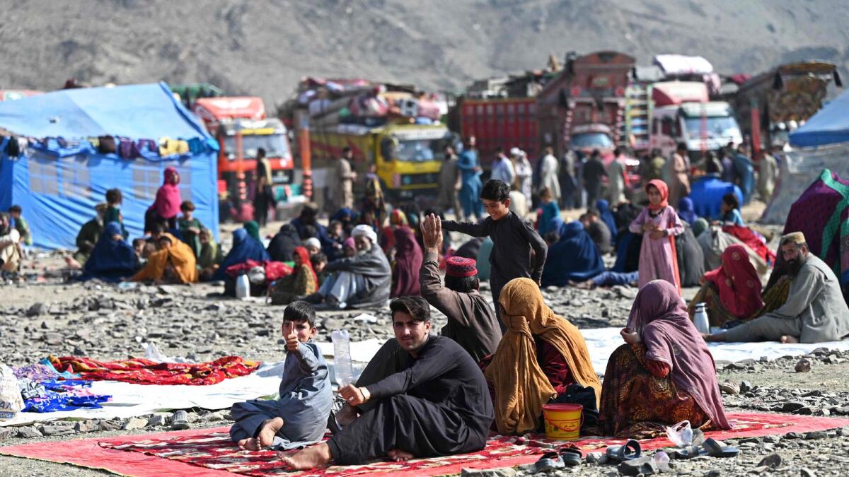 Afghan refugees rest at a makeshift camp upon their arrival from Pakistan, near the Afghanistan-Pakistan Torkham border in Nangarhar province on November 2, 2023. More than 165,000 Afghans have fled Pakistan in the month since its government ordered 1.7 million people to leave or face arrest and deportation, officials said on November 2. (Photo by Wakil KOHSAR / AFP)