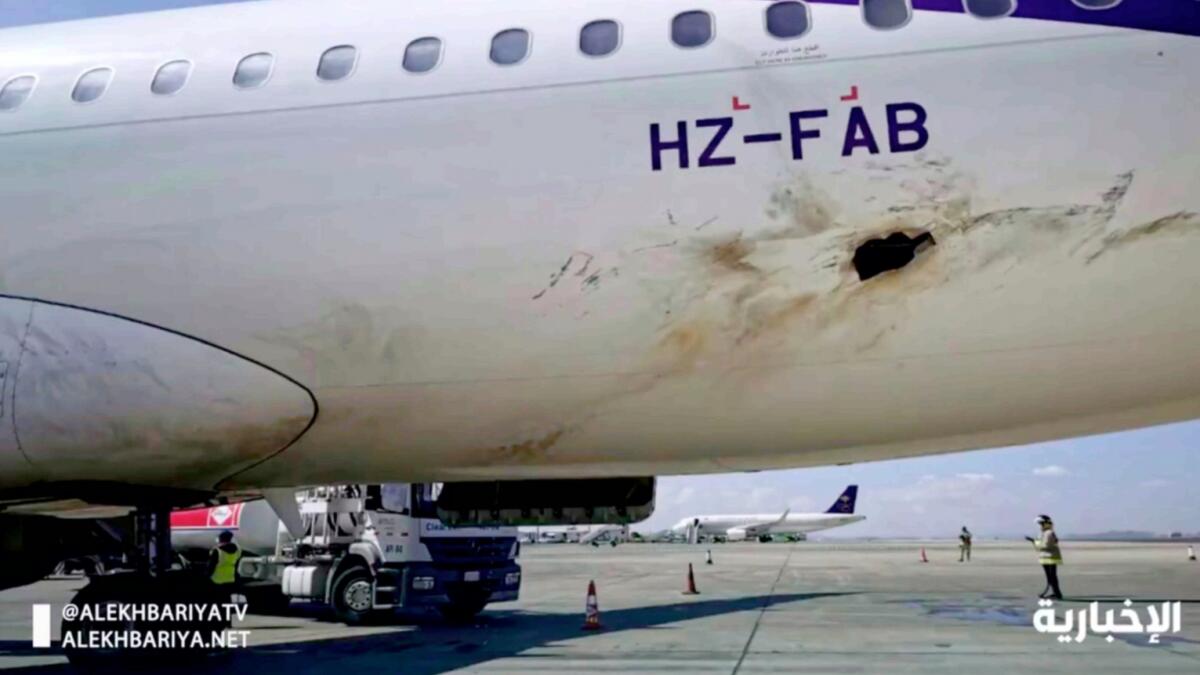 A screengrab from a video released by Saudi state television shows a plane damaged in an attack by Houthi rebels at an airport near Abha. — AP