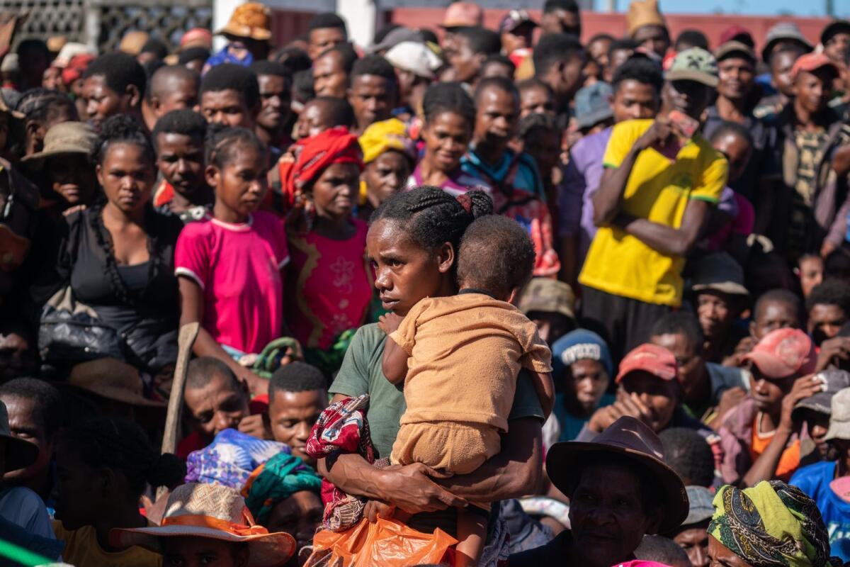 Displaced people at a food distribution site after destruction caused by Cyclone Batsirai in Nosy Varika, Madagascar, on June 10, 2022. — Joao Silva/The New York Times