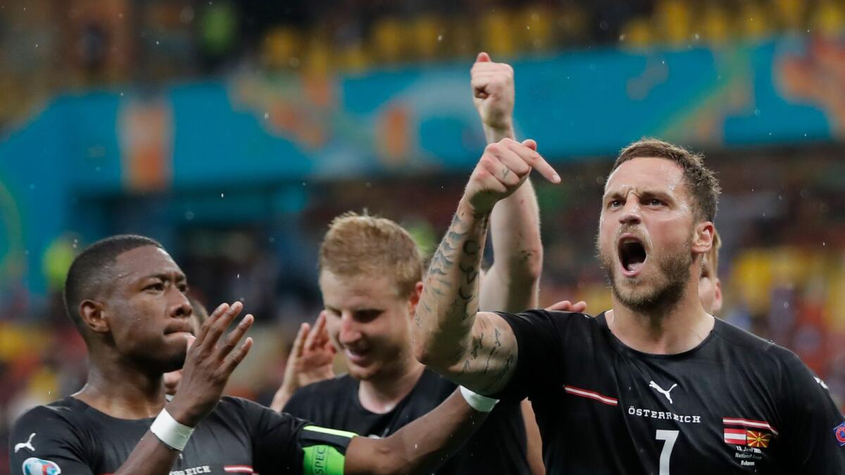 Austria's Marko Arnautovic (right) celebrates with teammates after scoring his side's third goal against Northern Macedonia. (AP)