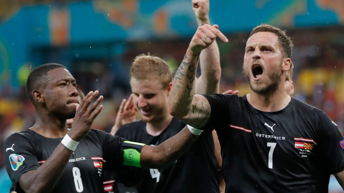 Austria's Marko Arnautovic (right) celebrates with teammates after scoring a goal against Northern Macedonia during the Euro 2020 championship. — AP