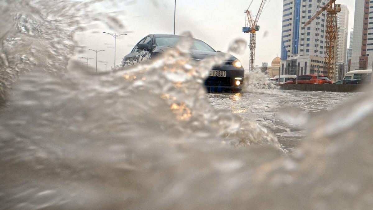 Rain impact: Car splashes through rainwater in Sharjah. Photo by Shihab