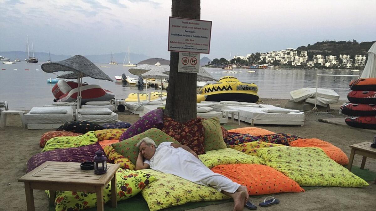 Tourists sleep outside as they were not allowed to enter the damaged buildlings