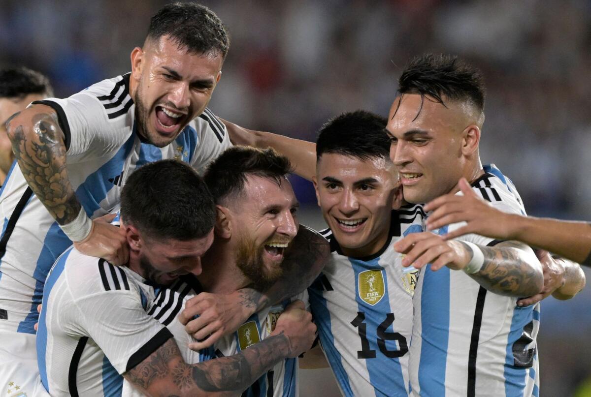 Lionel Messi (centre) celebrates with Leandro Paredes (left, top), Rodrigo De Paul (left), Thiago Almada (second right) and Lautaro Martinez after scoring a goal. — AFP
