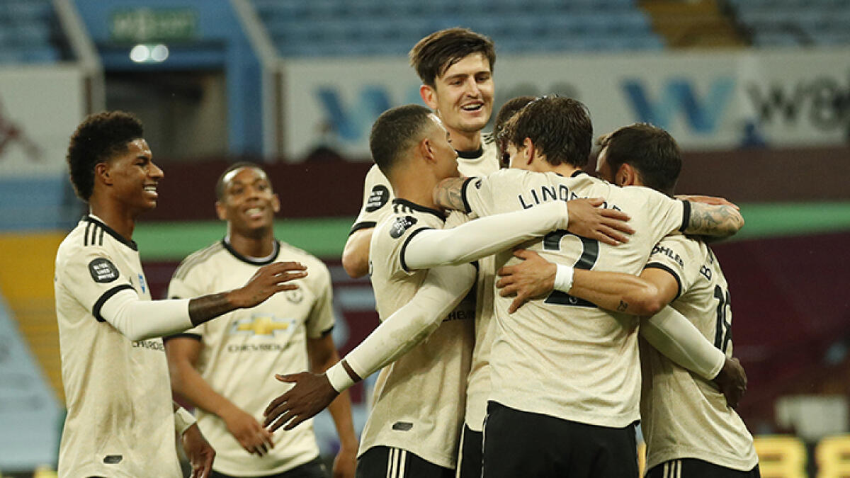 Manchester United's players celebrates the team's third goal during the English Premier League match against Aston Villa. -- AFP