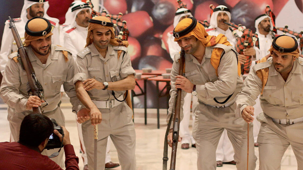 THEY TAKE PART, TOO ... Officers perform a traditional dance.- Photo by  M Sajjad/ Khaleej Times