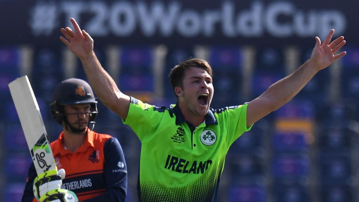 Ireland's Curtis Campher (right) celebrates after taking the wicket of Netherlands' Scott Edwards. (AFP)