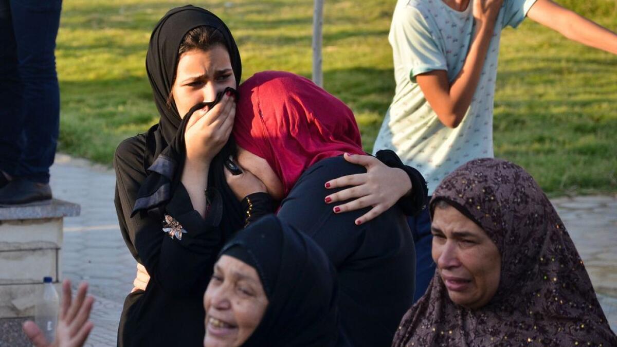 Egyptian women mourn for victims of a passenger boat after it sunk in the river Nile in Giza, south of Cairo, Egypt.
