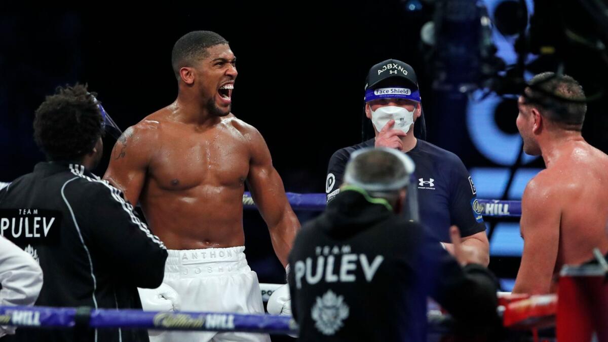 Anthony Joshua celebrates after beating challenger Bulgaria’s Kubrat Pulev in their Heavyweight title fight at Wembley. — AP