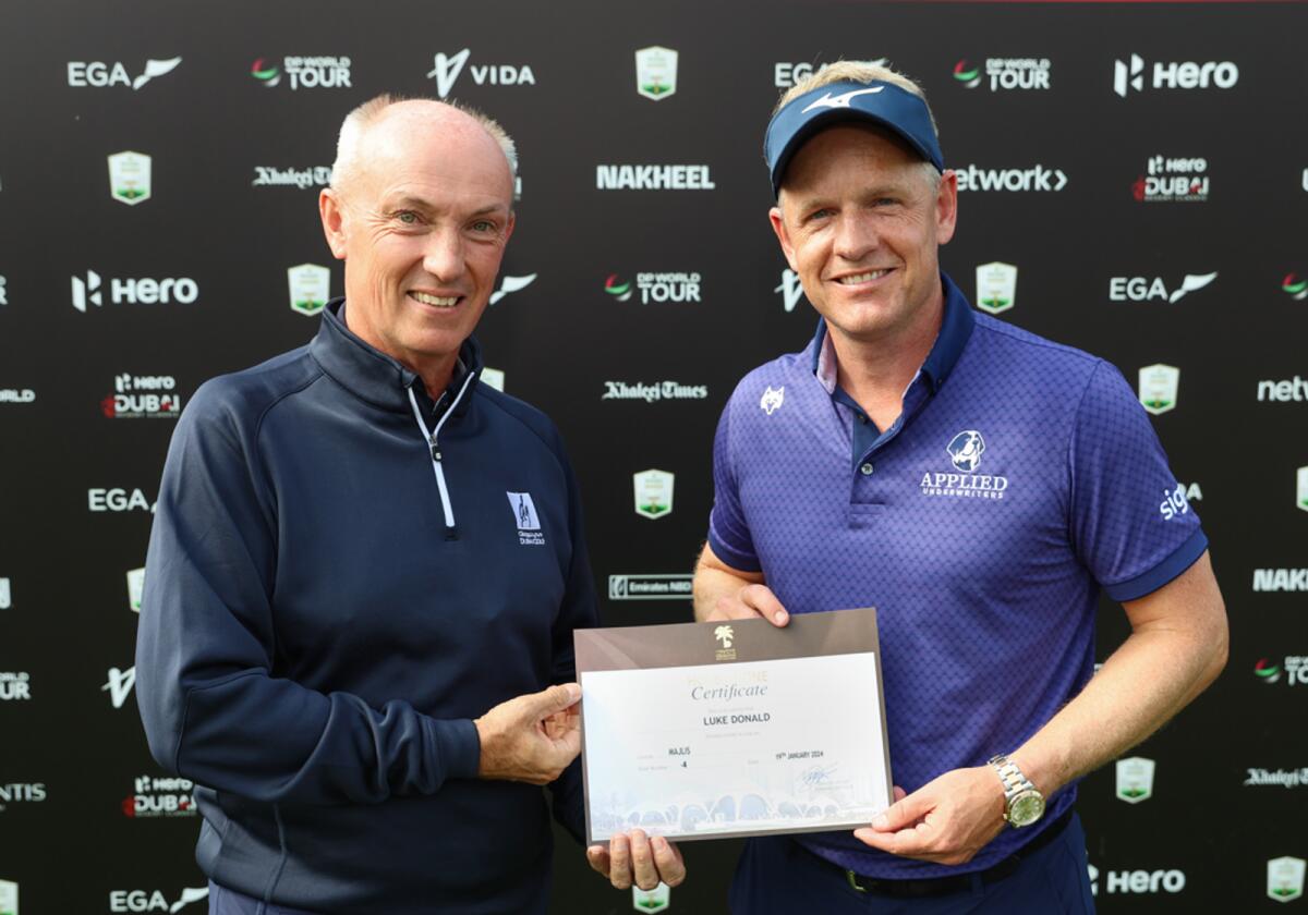 Chris May, CEO of Dubai Golf, presents a certificate to Luke Donaldat the Emirates Golf Club. - Supplied photo