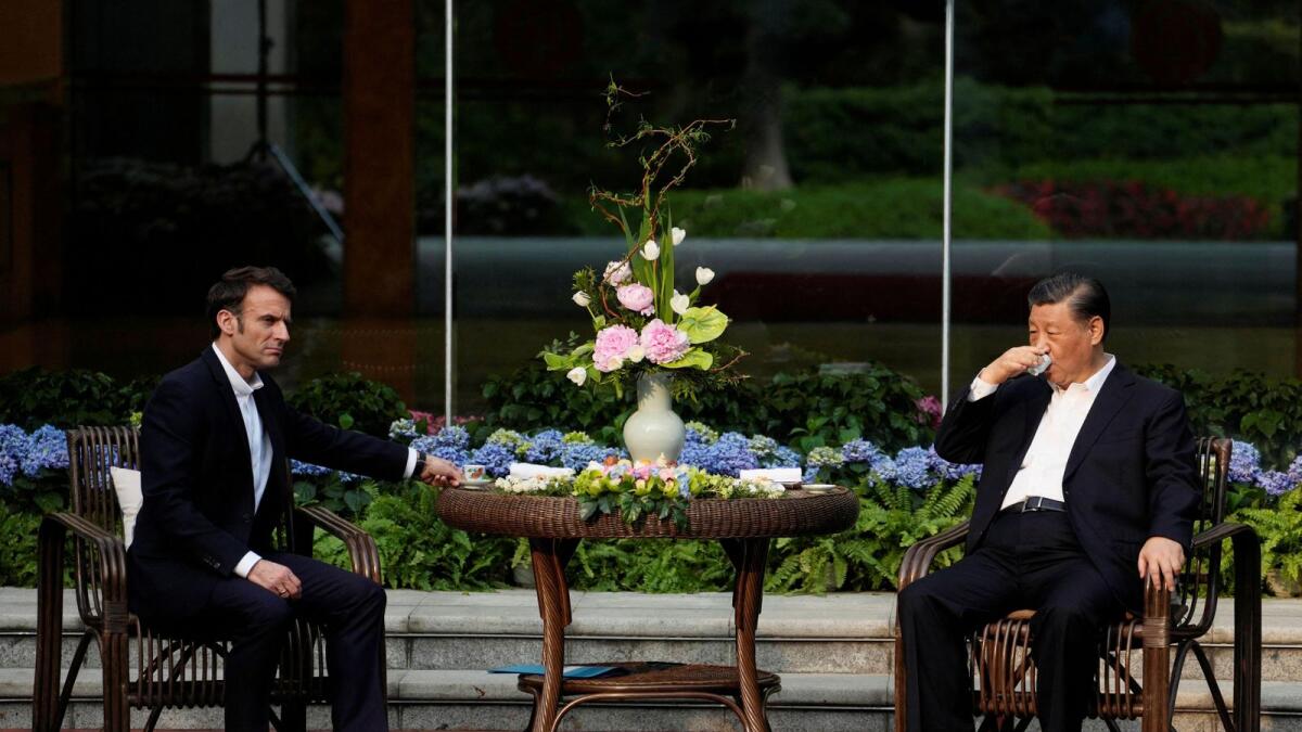 Chinese President Xi Jinping and France’s President Emmanuel Macron attend a tea ceremony at the Guandong province governor’s residence, in Guangzhou, China, on Friday. — Reuters