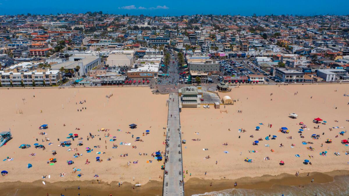 An aerial view shows people on the beach during a heatwave as coronavirus cases reach new record levels in states across the nation, in Hermosa Beach, California. Los Angeles County beaches are reopened after they were re-closed over the Fourth of July weekend because of fears that large gatherings would further accelerate the spread of Covid-19. Photo: AFP
