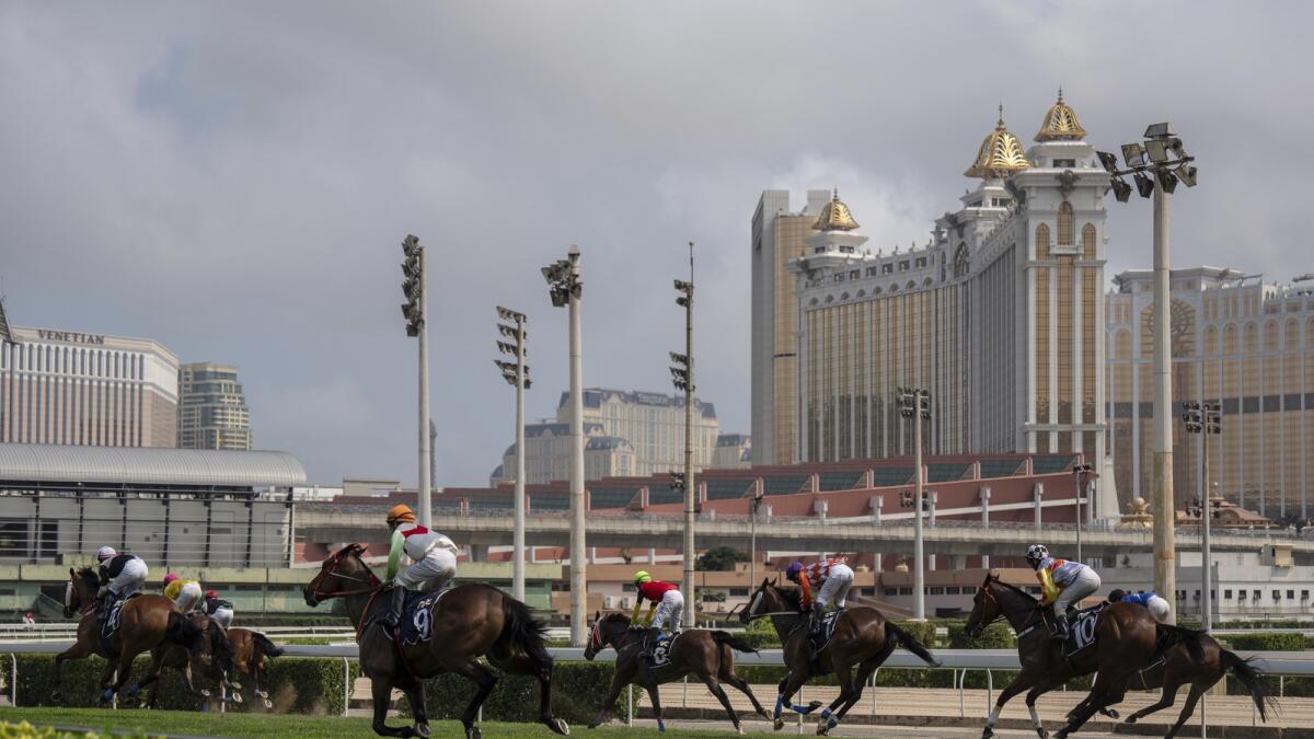 Jockeys compete in last Macao races at the Macao Jockey Club in Macao. — AP