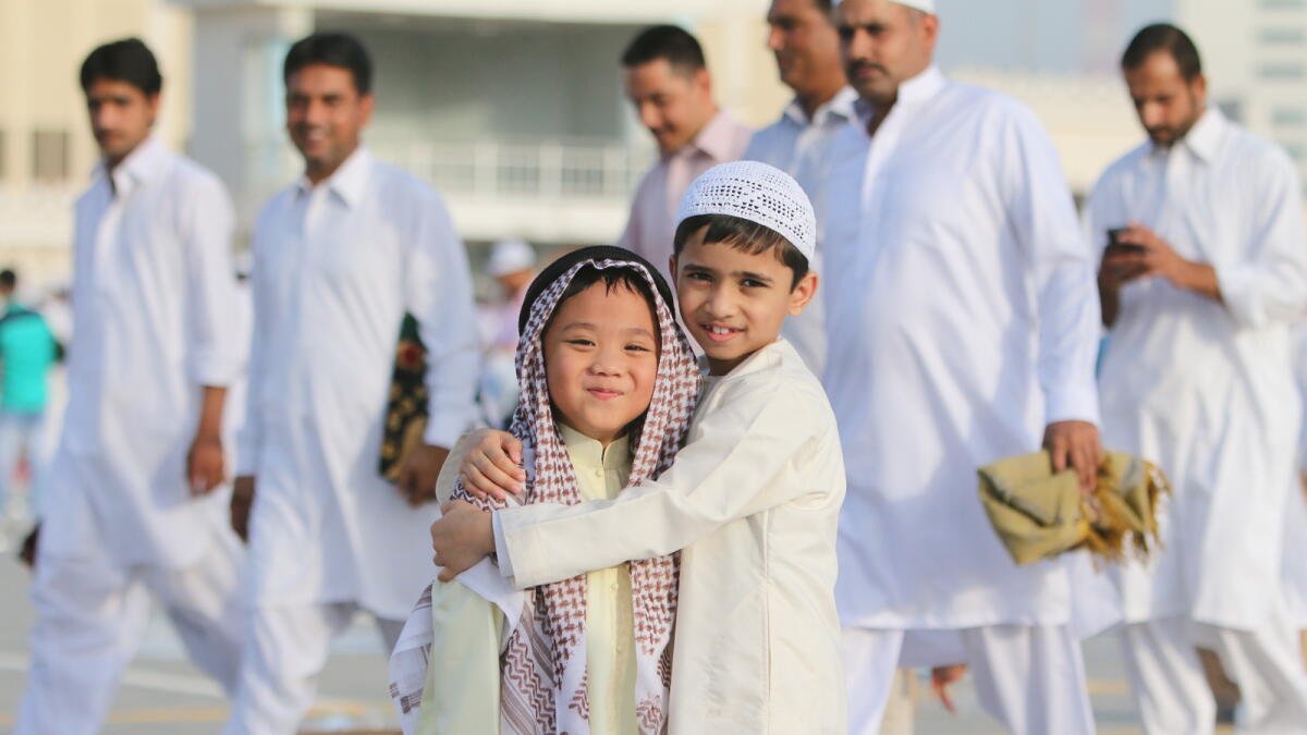 BROTHERLY AFFECTION ... Little ones greet each other after the Eid Prayer at Eid Musalla in Sharjah. - Photo by M Sajjad/ Khaleej Times