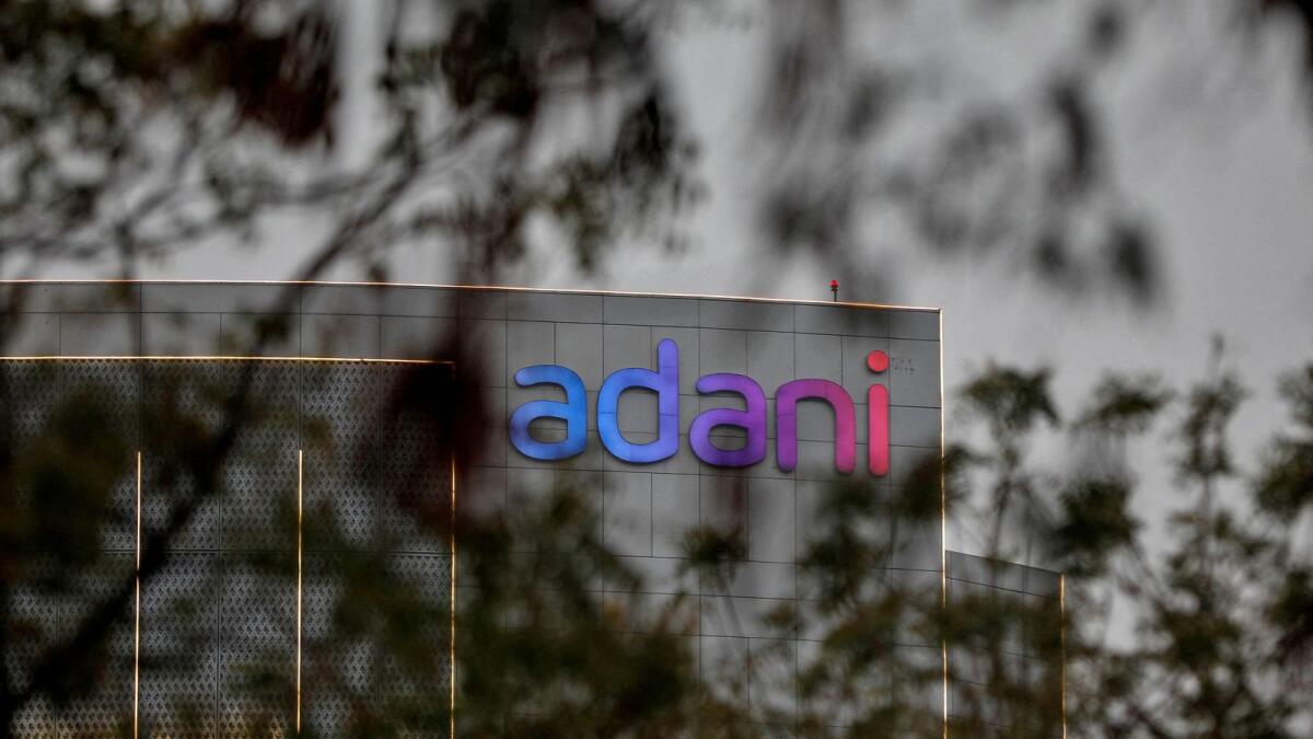 The logo of the Adani Group is seen on the facade of its Corporate House on the outskirts of Ahmedabad, India. — Reuters