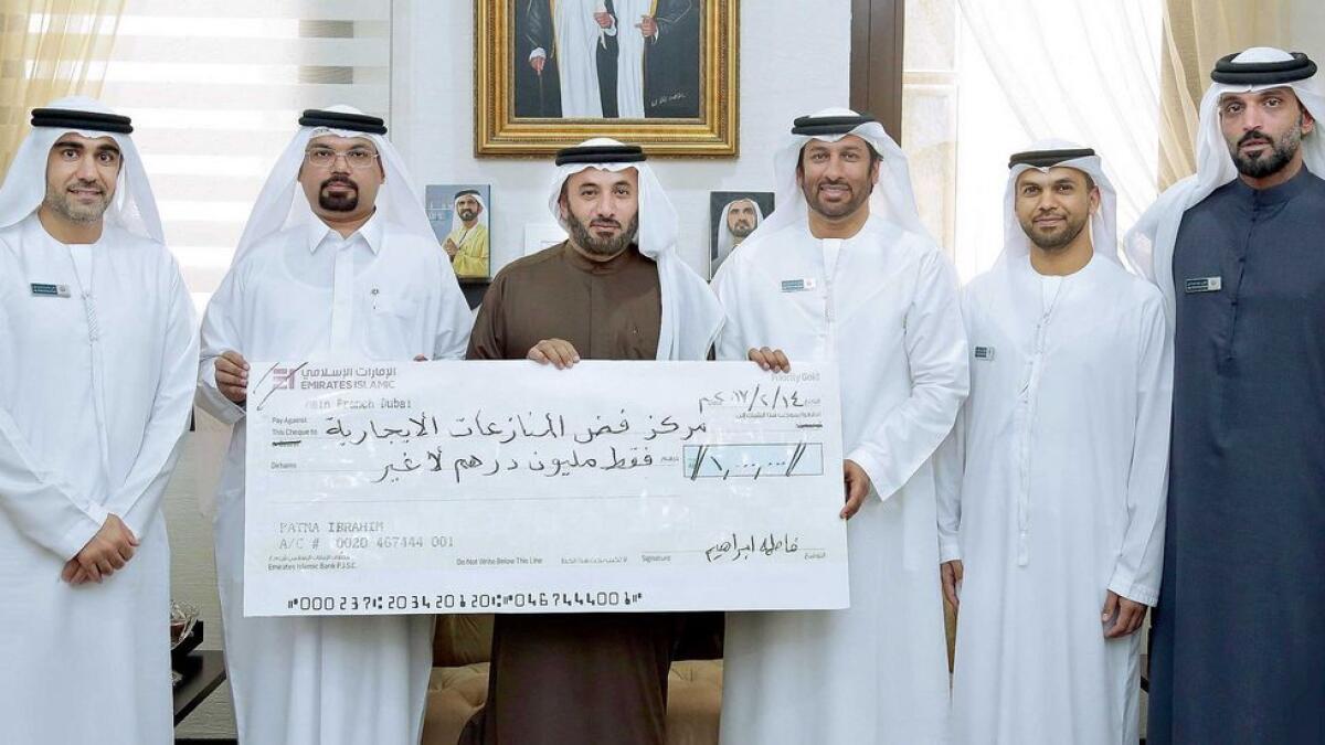 Representatives of the Rental Dispute Centre receive a cheque for Dh1 million from the family of the late Obeid Al Helou. The centre has set up a committee to study eligible cases. 