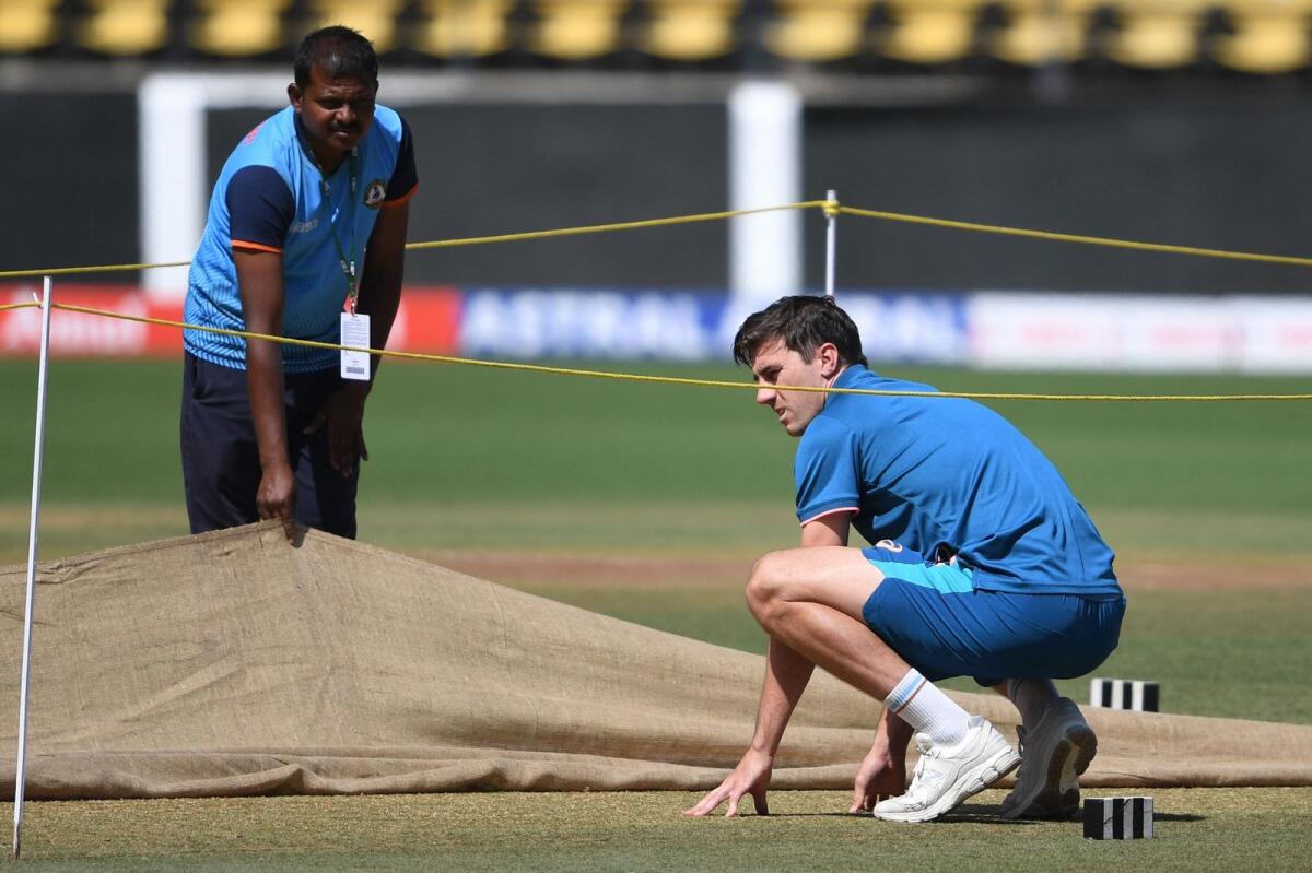 Australia's captain Pat Cummins (right) inspects the pitch during a practice session at the Vidarbha Cricket Association (VCA) Stadium in Nagpur on Wednesday. — AFP