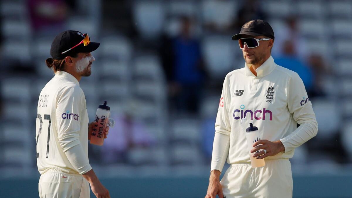 England's Rory Burns and Joe Root discuss a point during the fourth day.—  Reuters